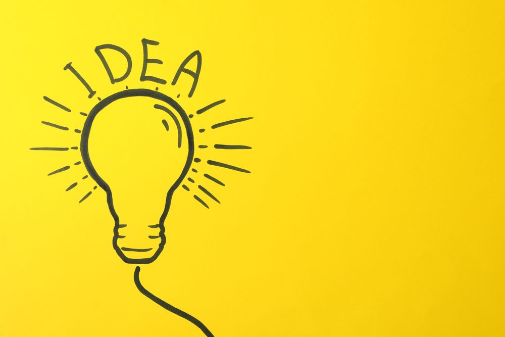 Drawn light bulb on yellow background. Good idea concept