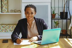Confident female business owner in her home office