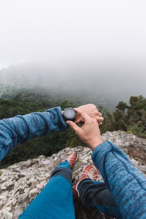 Man's hand with watch in the mountains