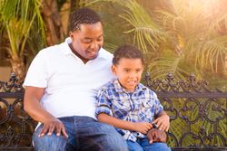 Black Father Playing With Son Outdoors