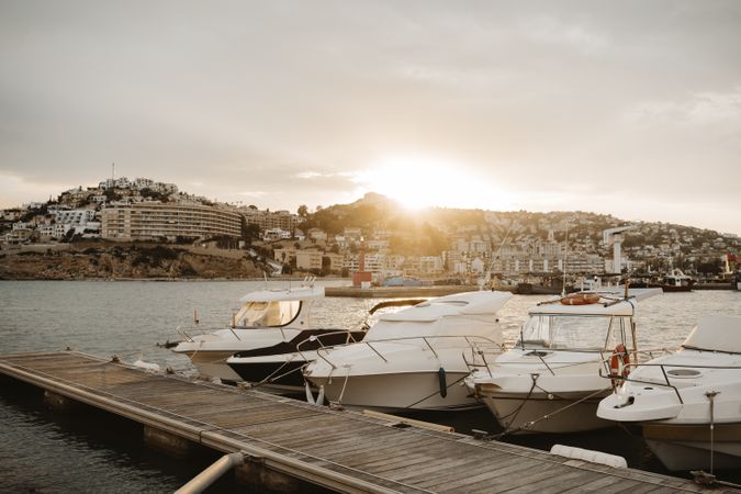 Yachts docked in sea port at sunset