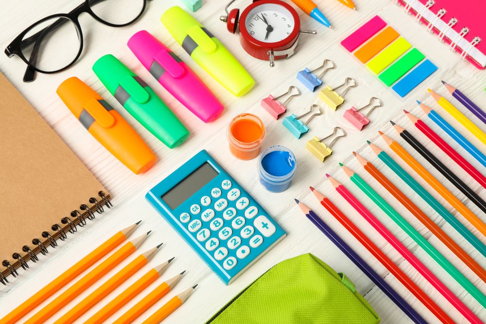 Flat lay composition with school supplies on wooden background