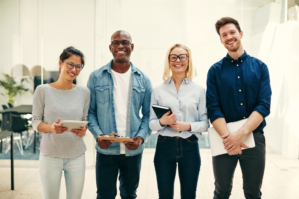Portrait of multi-ethnic group of colleagues standing together and smiling