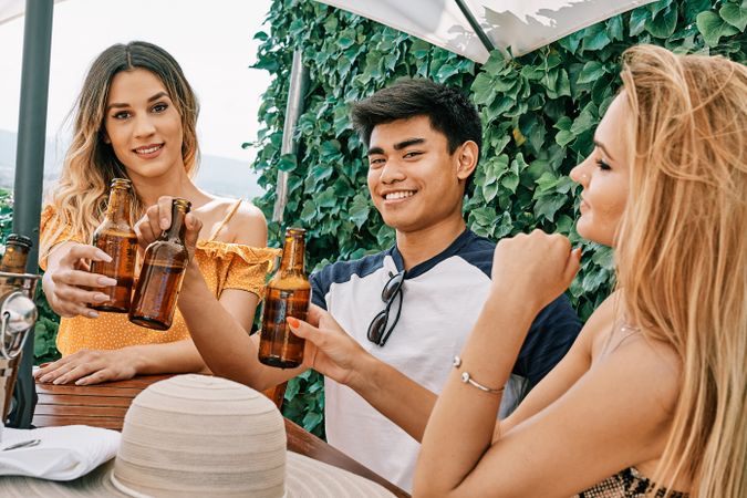 a group of young people cheering with beer in summer