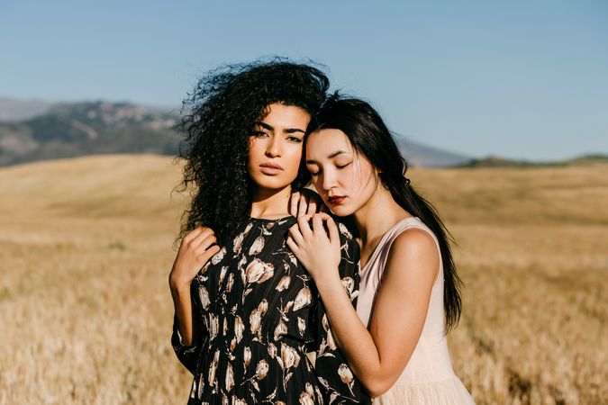 Female friends standing in field