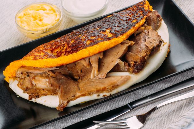Cachapa, typical Venezuelan dish made with corn and stuffed with cheese and pork