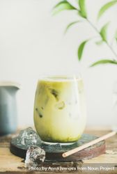 Iced matcha drink with pitcher on side, with eco friendly straw and leaves bGE1l5
