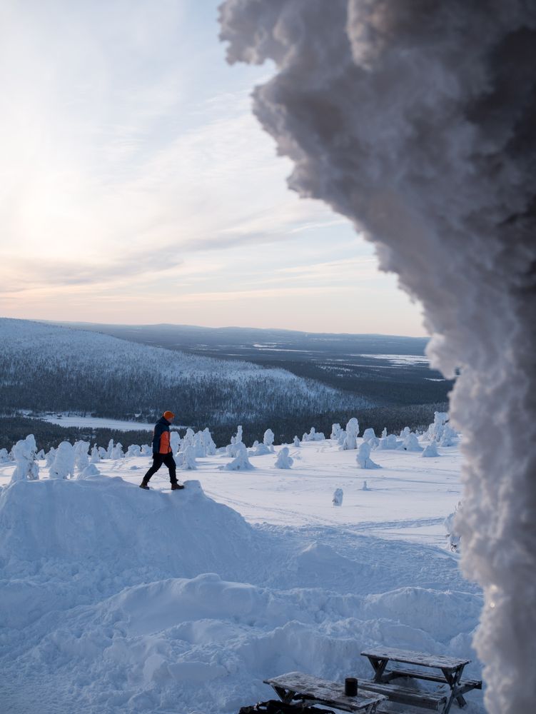 Person walking beside glacier in mountain