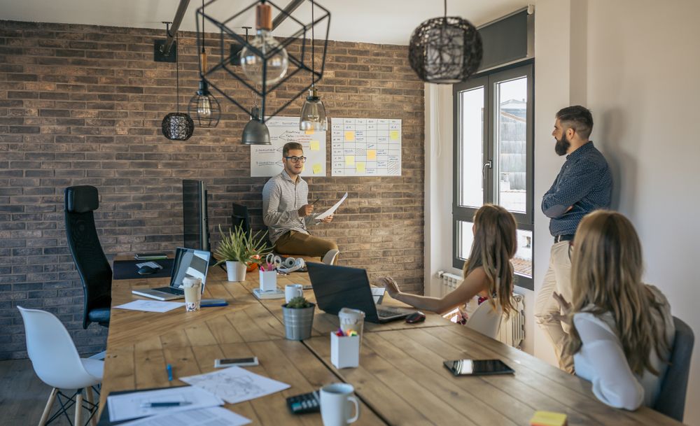 Coach giving a talk to workers in an office