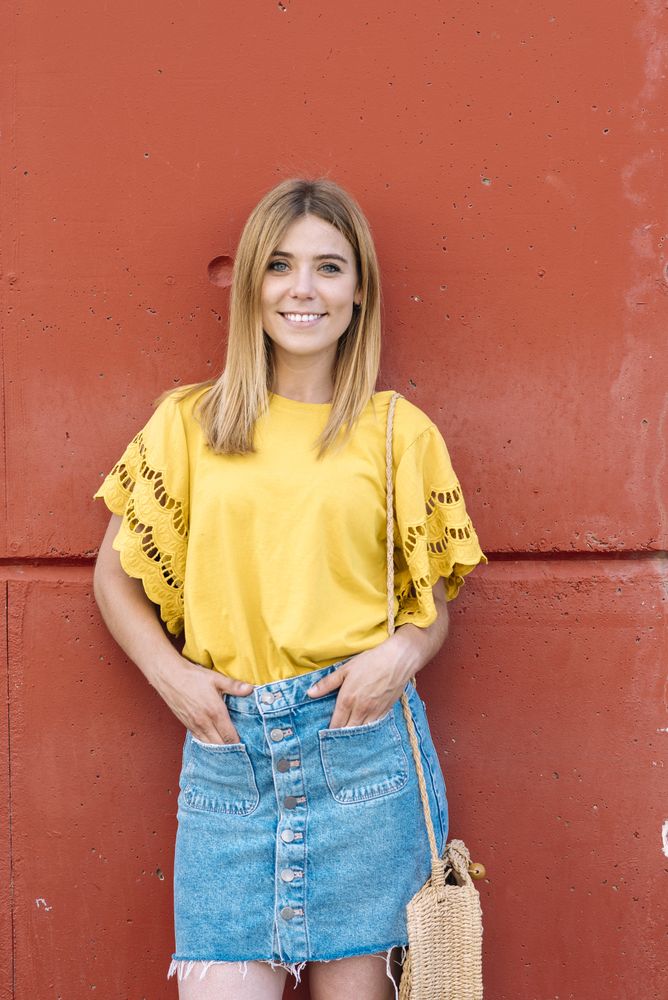 Cheerful woman standing on orange background