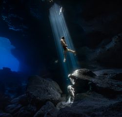 Man swimming to the surface in the ocean