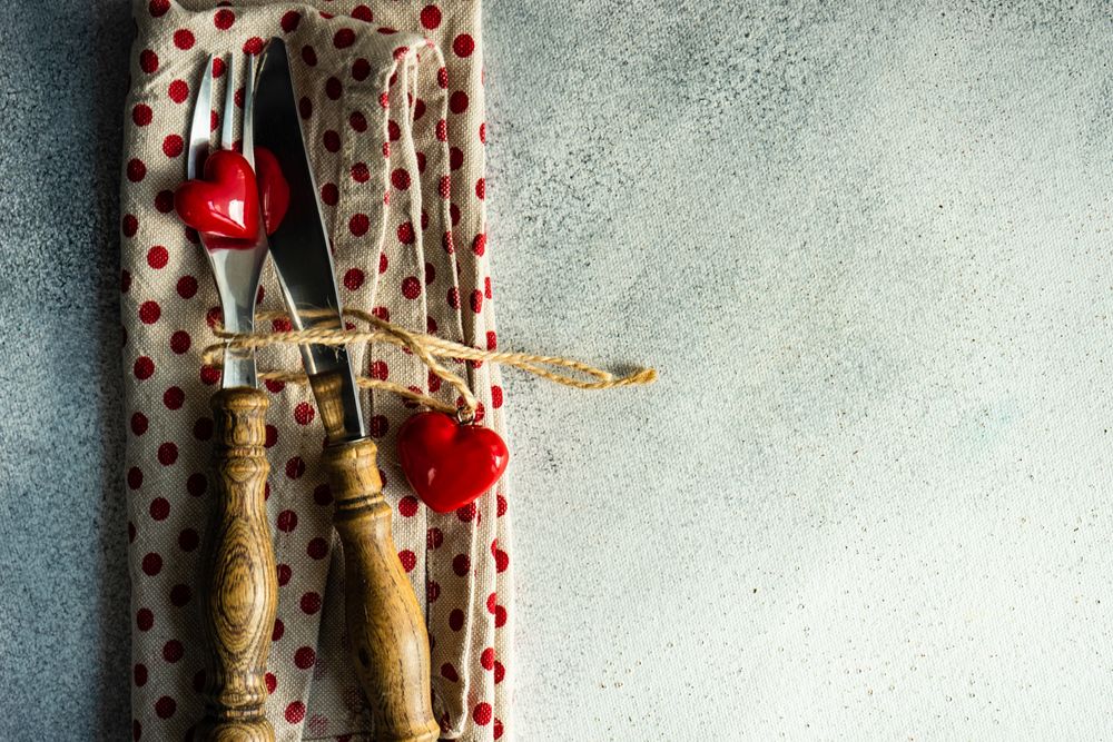 Silverware on dotted napkin with heart decorations