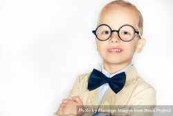 Cute blond boy in spectacles and bow tie 5RkKD4