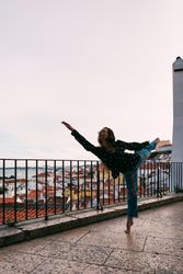 young dancer dancing against cityscape