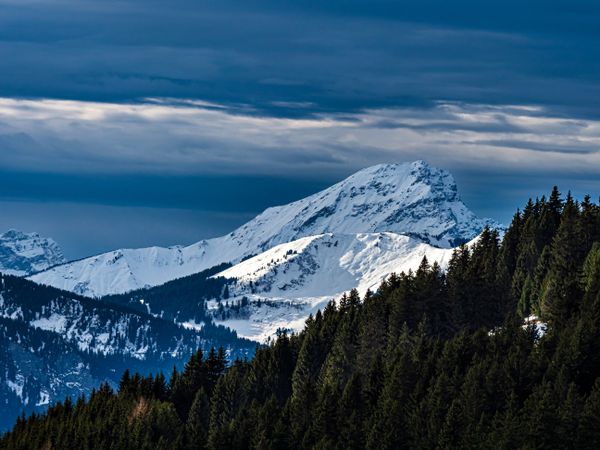 Swiss Alps winter landscape with snow and sun, mountains in Europe
