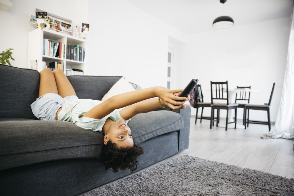 Girl watching tv in living room
