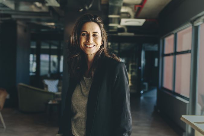 Smiling female executive standing in office