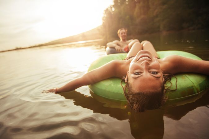 Young couple in lake on inflatable rings