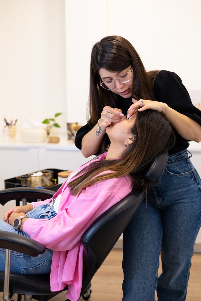 Beautician making eyelash lamination and dyeing procedures