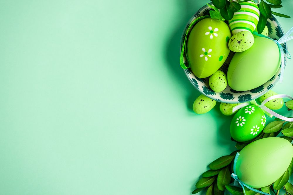 Easter card concept with bright green decorative Easter eggs in bowls
