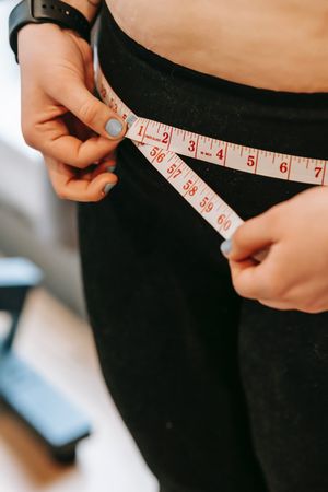Woman measuring her hip