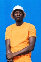 Black man in bright sporty outfit and cap