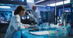 Medicine Development Laboratory: Female Scientist Using Microscope, Analyzes Petri Dish Sample.