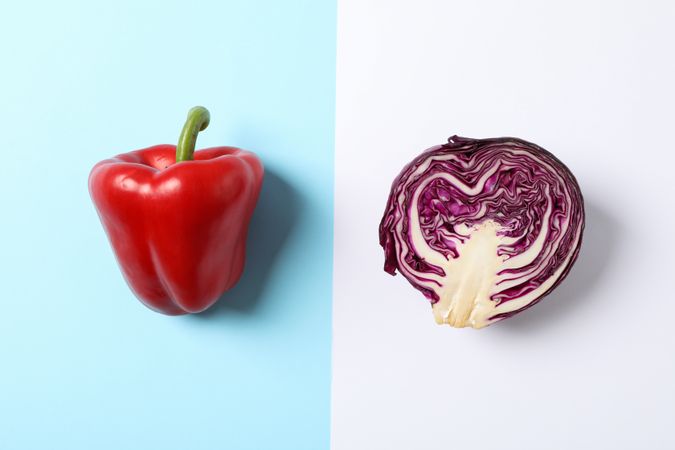 Cabbage and pepper on two tone background, space for text