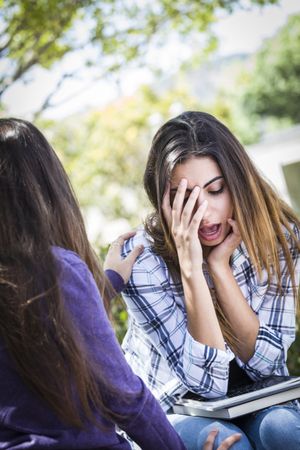 Stressed Female Being Comforted By Friend
