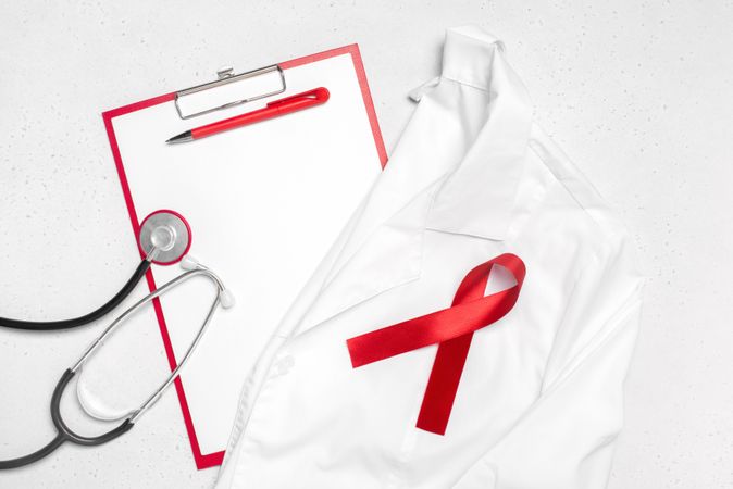 Red ribbon on doctor’s coat and stethoscope