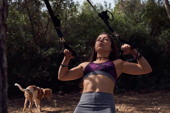 Female athlete doing sports and walking dog