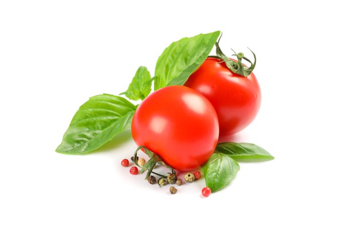 Fresh cherry tomatoes with basil and spices isolated on blank background. Ripe vegetables