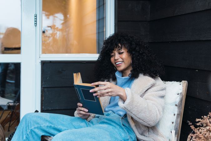 Black woman reading book outside