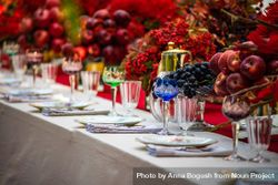 Elegant formal dinner table with glass ware and bowls of fruit 5lAKv4
