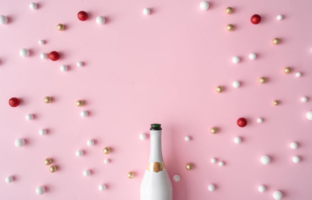 Champagne bottle with red, gold and glitter decorated balls