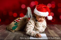 Child concentrating on writing a letter to Santa at Christmas time 5kJxG0