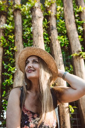 Smiling woman in straw hat looking away
