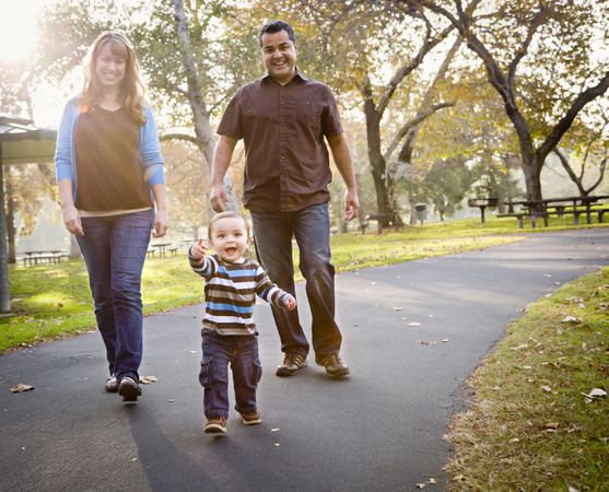 Happy Family Walking In The Park