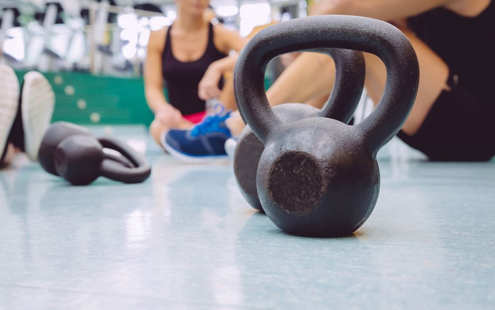 Kettle bells on busy gym floor