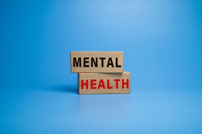 mental health words symbol on wooden blocks on blue background