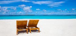 Blue sky over a tropical beach with blue water and sand