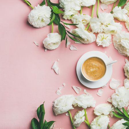 Morning caffeine with pretty flowers over pink background