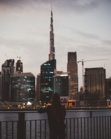 Person on seafront of modern metropolis