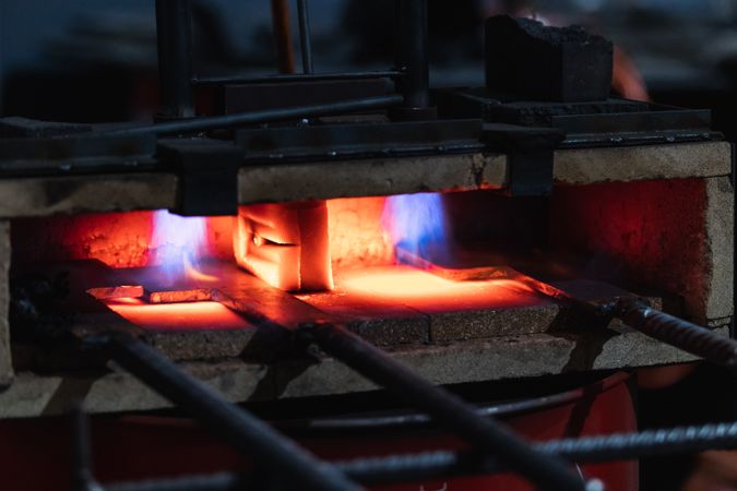 Metal detail burning in furnace in workshop