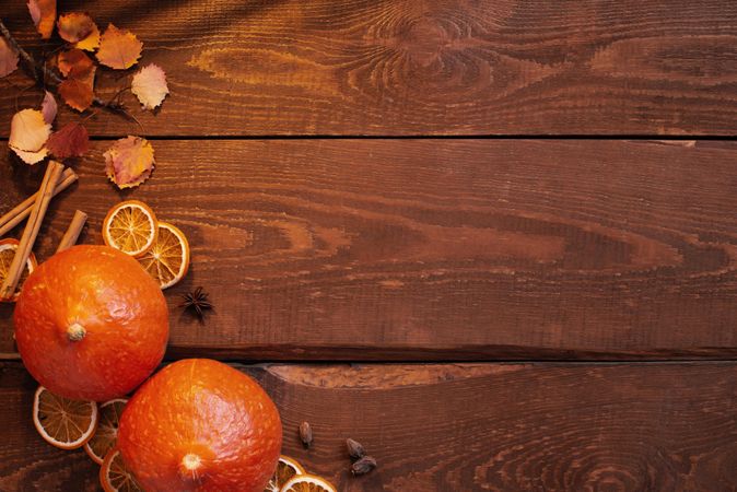 Squash and dried orange on rustic wooden table with copy space