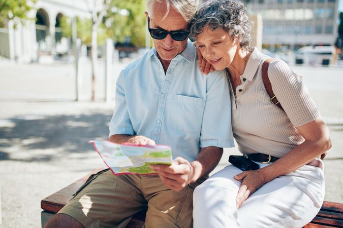 Older couple looking for destination on a city map