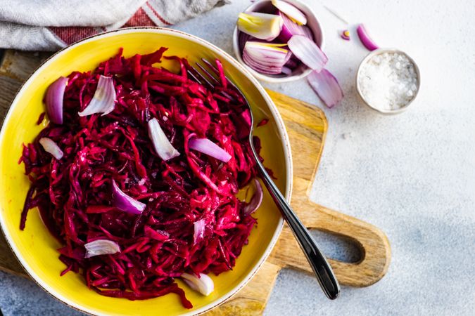 Top view of cabbage and beetroot salad yellow bowl