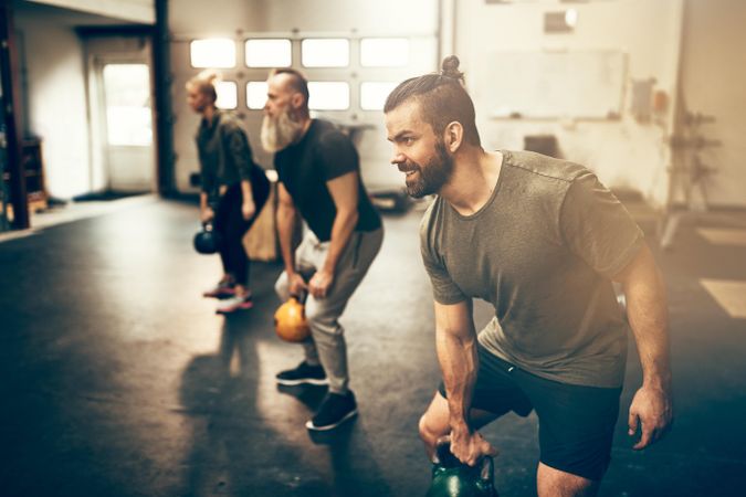 Group of people in workout class with kettlebells
