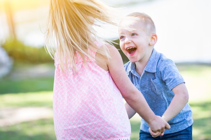Young Brother and Sister Playing At The Park Togther