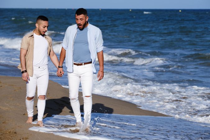 Gay couple walking on beach